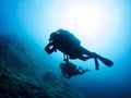 two scuba divers swimming in the ocean Royalty Free Stock Photo