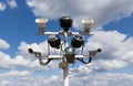 Two security cameras, floodlights and loudspeakers against the blue sky