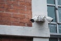 Security cameras mounted on a brick wall near a window Royalty Free Stock Photo