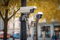 Two security cameras monitoring urban life in a busy city street. Generative AI illustration Royalty Free Stock Photo