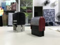 Two self inked printer dater on top of a beige desktop in the workplace Royalty Free Stock Photo