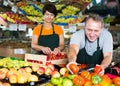 Two sellers are offering red tomatos