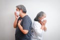 two senior asians wearing a white mask standing with his back Sick with the flu, symptoms of corona virus disease. Royalty Free Stock Photo