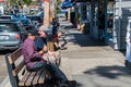 Two senior citizen caucasian male friends on a bench in the shopping district of Balboa Island Royalty Free Stock Photo
