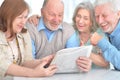 Senior couples reading newspaper Royalty Free Stock Photo