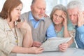 Senior couples reading newspaper Royalty Free Stock Photo