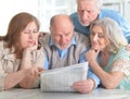 Senior couples reading newspaper Royalty Free Stock Photo