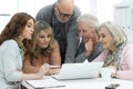 Two senior couples talking with consultant while sitting at table Royalty Free Stock Photo