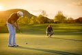 Two senior golf player at sunset. Royalty Free Stock Photo