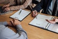 Two senior manager reading a resume during a job interview, Employer interviewing to ask young male job seeker for recruitment ta Royalty Free Stock Photo