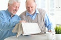 Two senior men reading newspaper Royalty Free Stock Photo