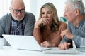 two senior men and woman sitting at table Royalty Free Stock Photo