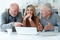 two senior men and woman sitting at table Royalty Free Stock Photo