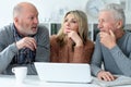 two senior men and woman sitting at table Royalty Free Stock Photo