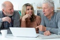 Two senior men and woman sitting at table Royalty Free Stock Photo