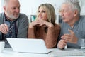 two senior men and woman sitting at table Royalty Free Stock Photo