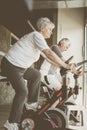 Two senior people working out on elliptical machine. Royalty Free Stock Photo