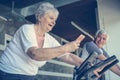 Two senior people working out on elliptical machine. Royalty Free Stock Photo