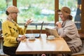 Two senior women in cafe.