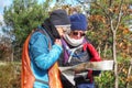 Two senior women consulting a map while hiking in the fall in the Adirondack mountains Royalty Free Stock Photo