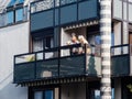 Two senior women on the large balcony breathing fresh air in French architecture