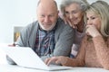 two Senior women and man using laptop Royalty Free Stock Photo
