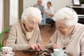 Two Senior Women Playing Dominoes