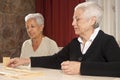 Two Senior Women Playing Dominoes