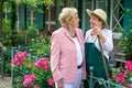 Two Senior Women Talking Together in Garden Royalty Free Stock Photo