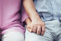 Two seniors clasping hands together. Royalty Free Stock Photo