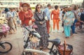 Two seniors women in vintage clothing meeting with youth during the city festival in Europe. Royalty Free Stock Photo