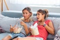 Two sentimental women friends upset crying and wiping tears with handkerchiefs while watching dramatic, sad movie, TV reality show Royalty Free Stock Photo