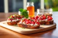 two separate slices of bruschetta, one with strawberries, one with raspberries