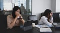 Two serious businesswomen colleagues having disagreement in office.