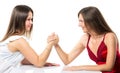 Two serious competetive women having arm wrestling fight, compete with each other.