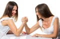 Two serious competetive women having arm wrestling fight, compete with each other.