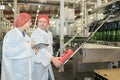 Two serious manual workers doing their job on factory production Royalty Free Stock Photo