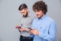 Two serious men using smartphone Royalty Free Stock Photo