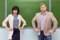 Two serious teachers a man and a woman in classroom Royalty Free Stock Photo