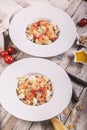 Two servings of Caesar salad with fried shrimp, quail eggs and parmesan cheese on a white plate. Mediterranean Kitchen. Close-up. Royalty Free Stock Photo