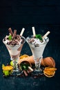 Two servings of ice cream. On a black wooden background. Royalty Free Stock Photo