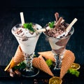 Two servings of ice cream. On a black wooden background. Royalty Free Stock Photo