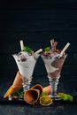 Two servings of ice cream. On a black wooden background. Royalty Free Stock Photo