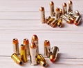 Two sets of 40 caliber bullets and 44 special bullets on a white wooden background Royalty Free Stock Photo