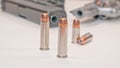 Two sets of different bullets with a revolver and a pistol in the background Royalty Free Stock Photo