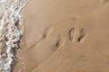 Two sets of footprints in the sand on a walk in Maui Hawaii Royalty Free Stock Photo