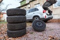 Two sets of winter wheels and tyres ready for replacement at car, copyspace Royalty Free Stock Photo
