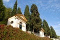 Two of the seven churches, walls covered with capers and large cypresses in Monselice through the hills in the Veneto (Italy)