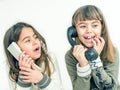 Two seven year old girls talking on the old vintage phones with Royalty Free Stock Photo