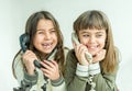 Two seven year old girls talking on the old vintage phones with Royalty Free Stock Photo